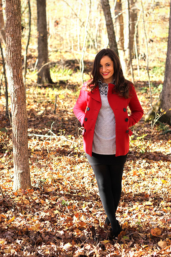 Brooke of Pumps and Push Ups wearing a mini skirt,tights, booties, red coat with button down and statement necklace 