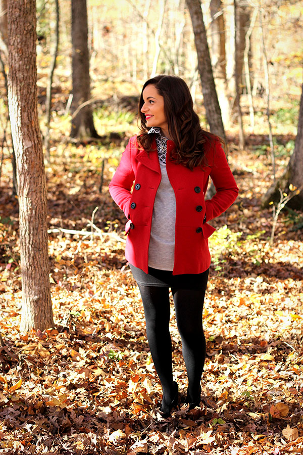 Brooke of Pumps and Push Ups wearing a mini skirt,tights, booties, red coat with button down and statement necklace