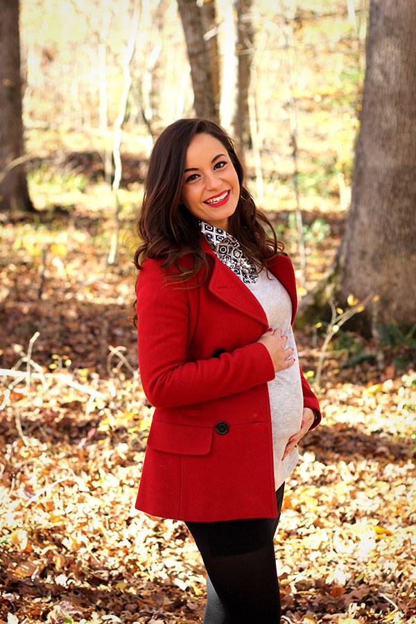 Brooke of Pumps and Push Ups wearing a mini skirt,tights, booties, red coat with button down and statement necklace