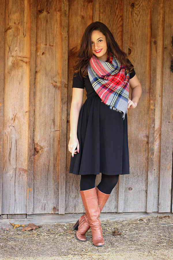 Brooke of Pumps and Push Ups wearing a black ASOS maternity dress with riding boots, tartan scarf and a red coat