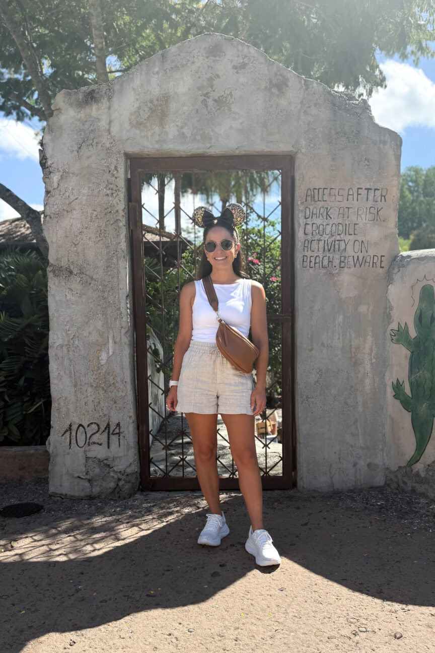 Disney outfit idea for summer! Linen shorts and a cotton white tank top. Styled by petite style blogger Brooke of Pumps and Push-Ups