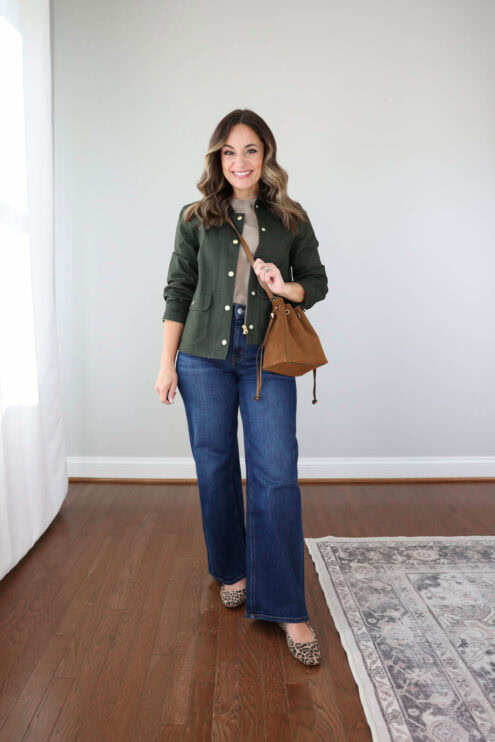 Petite style blogger Brooke of Pumps and Push-Ups styling wide-leg jeans for fall with an olive barn jacket, tan short sleeve sweater and leopard print flats.