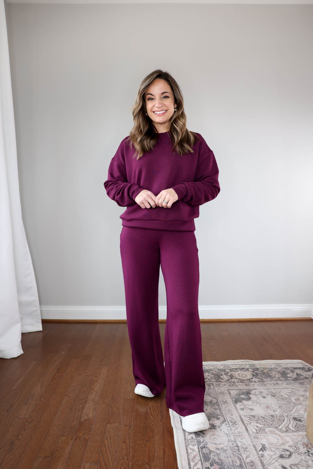 Brooke of Pumps and Push-Ups wearing Spanx AirEssentials Wide-Leg Pants and Crewneck Sweatshirt — cozy petite-friendly matching set for winter travel.
