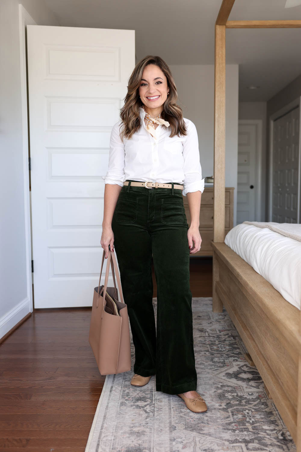 Brooke of Pumps and Push-Ups wearing LOFT Palmer Pants in dark green styled with a white button-down, neck scarf, and ballet flats — petite-friendly casual work outfit.