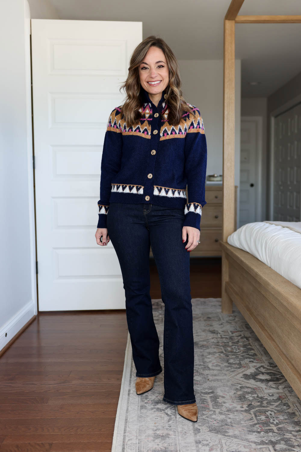 Brooke of Pumps and Push-Ups wearing a Fair Isle cardigan from Anthropologie in Petite XXS with J.Crew petite bootcut jeans — festive Thanksgiving outfit for petites with jeans.