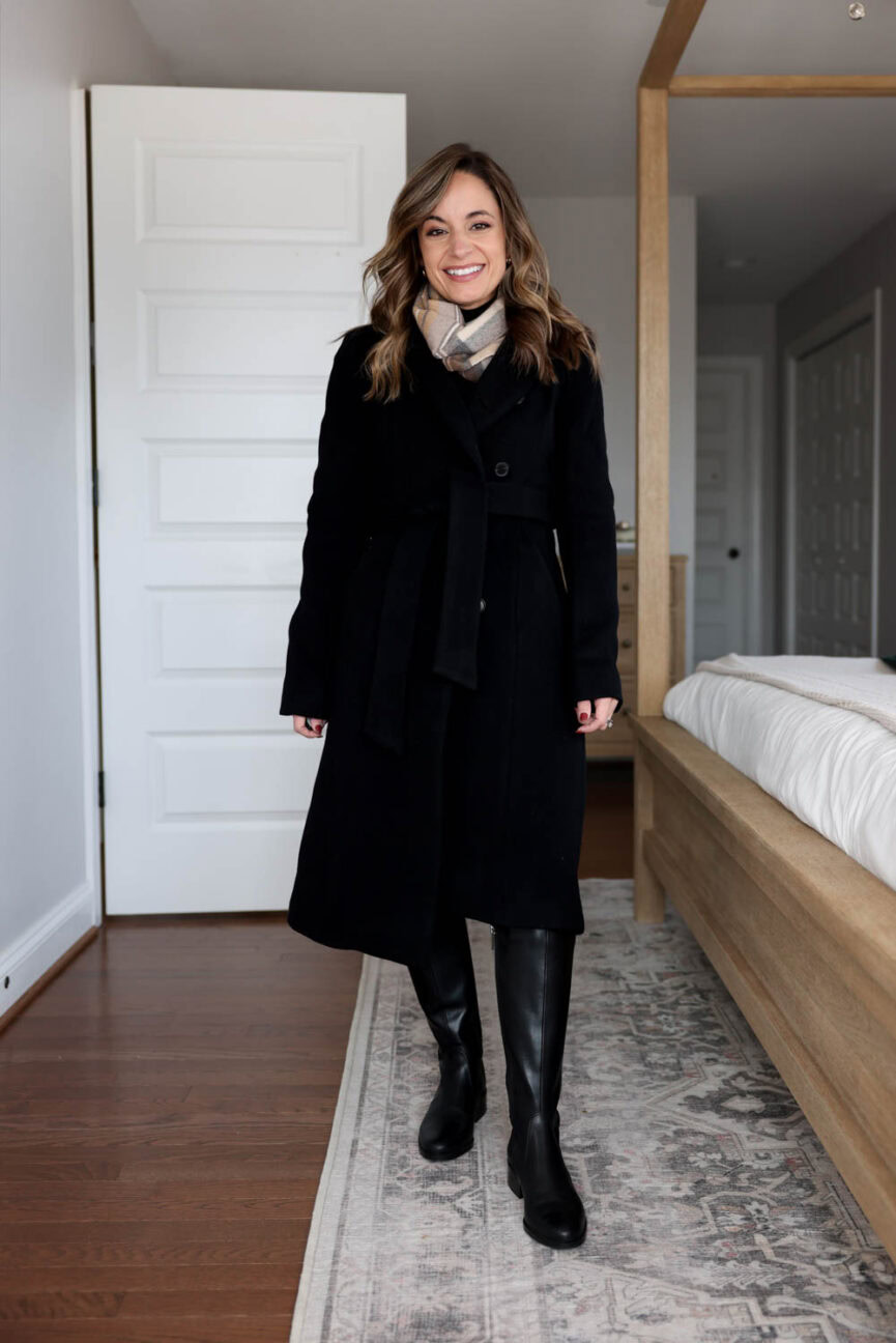 Brooke of Pumps and Push-Ups in an all-black petite Thanksgiving outfit — & Other Stories skirt, black turtleneck, Aritzia Heirloom Coat, and knee-high boots.
