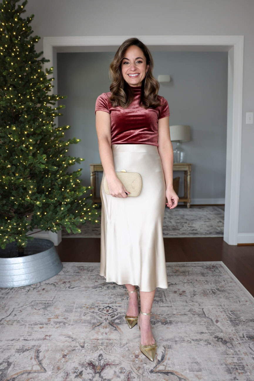 Brooke of Pumps and Push-Ups wearing a Banana Republic Factory velvet mock-neck top in XXS paired with a Quince silk skirt in XS for an elegant petite-friendly holiday outfit.