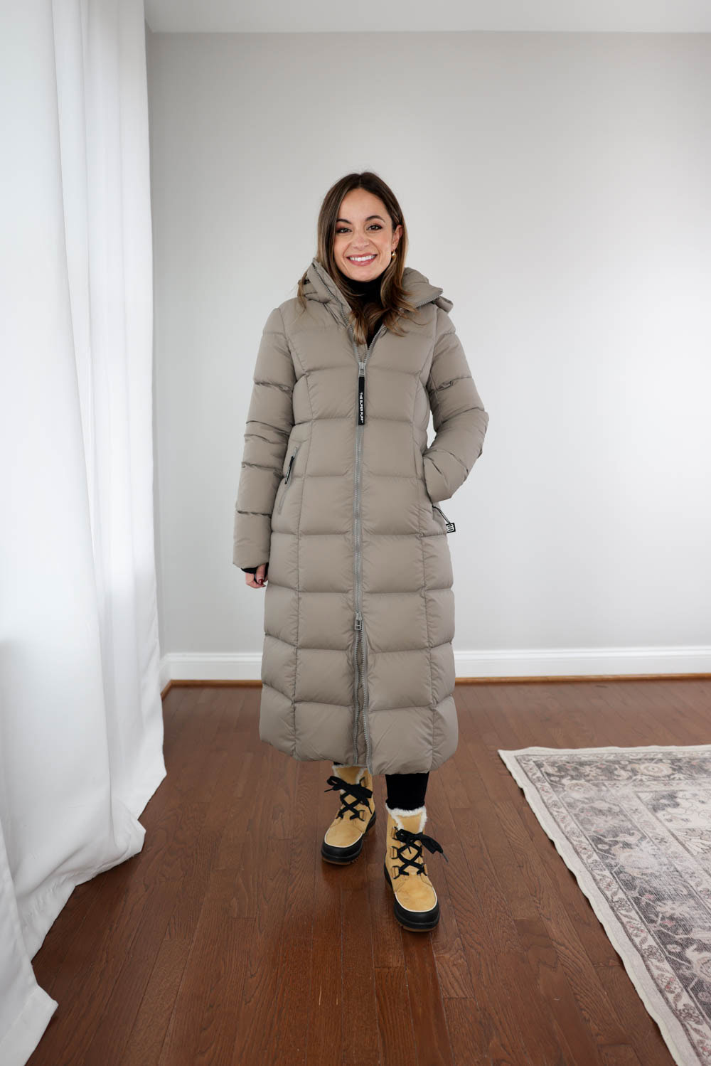 Supersnug Long Super Puff coat on 4’10” petite model Brooke, showing full-length winter coverage and proportioned shape.