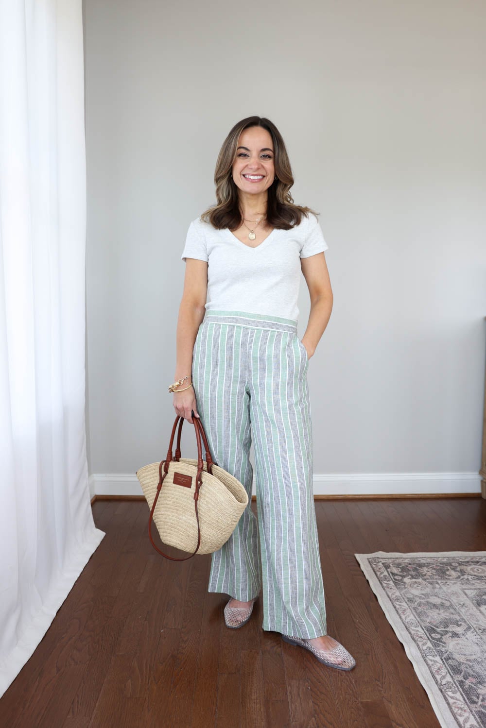 Petite summer outfit with striped cotton linen pants from LOFT and clear jelly shoes styled on a 4’10” frame for an easy casual summer look.