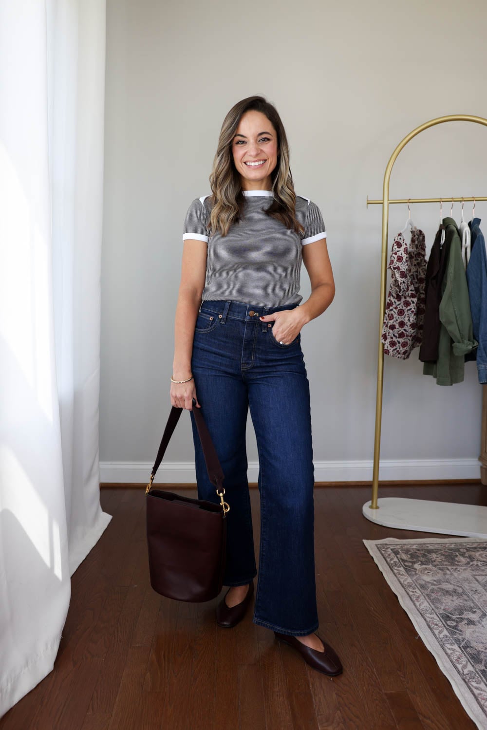 Petite-friendly capsule wardrobe idea with dark wash jeans and a chocolate brown striped top 